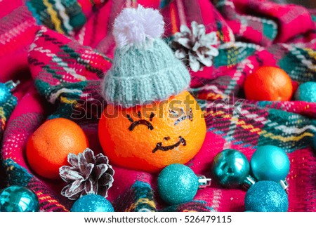 tangerine in a Christmas woolen hat .Xmas New Year concept