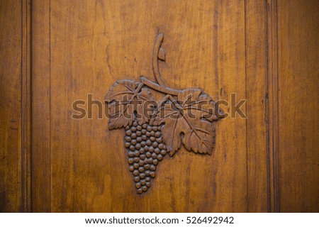 wooden door with wine grapes carved into it, Sion, Switzerland