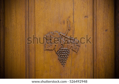 wooden door with wine grapes carved into it, Sion, Switzerland