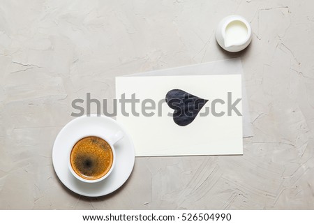 Mockup. blank paper and cup of coffee on gray concrete background. Top view