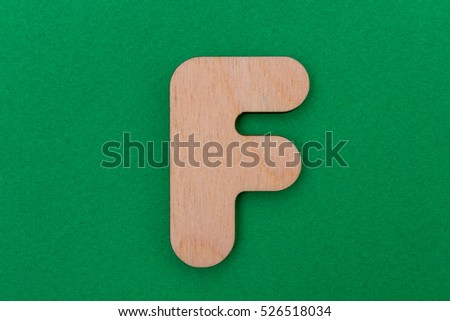 English alphabet made of wood are isolated on a green background. Latin.