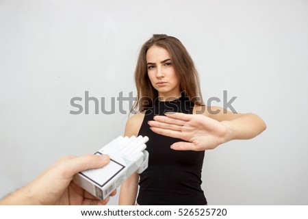 The social problem. Young unhappy woman, rejection box of cigarettes. negative attitude to smoking Royalty-Free Stock Photo #526525720