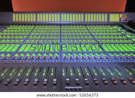 audio post production mixing console with lights on