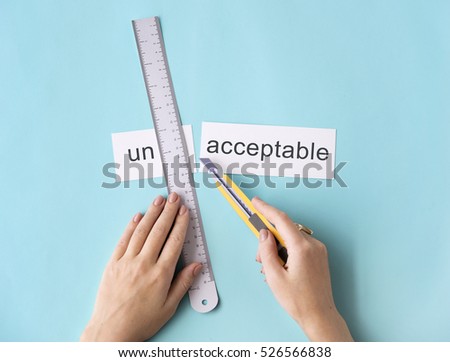 Unacceptable Unwelcome Hand Cut Word Split Concept Royalty-Free Stock Photo #526566838