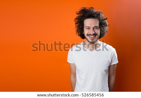 Beautiful caucasian man with funny hair over color background with copyspace