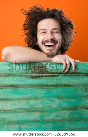 handsome young man with rustic plane on color background, copy space on rustic surface