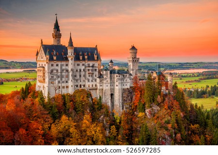 Amazing sunset view on Neuschwanstein Castle with colorful sky and autumn trees. Bavaria, Germany. Royalty-Free Stock Photo #526597285