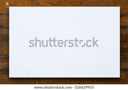 Old textured paper sheet on a dark wood table. horizontal Mockup