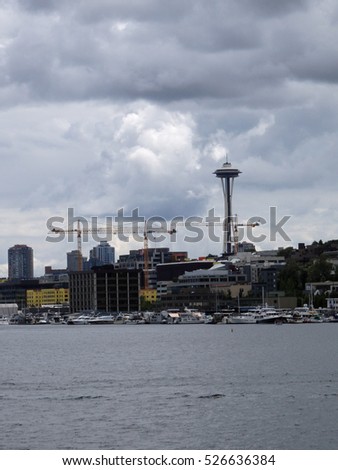Union Lake with Downtown skyscrapers under construction and the Space Needle in the distance in Seattle, Washington, USA clouds in the sky.  June 2016.