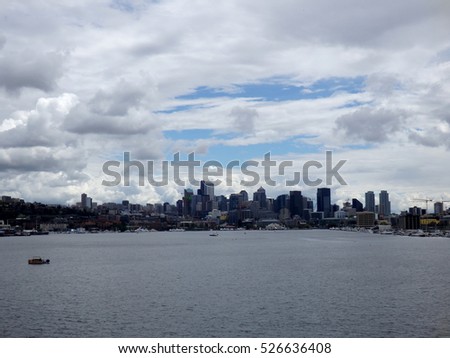 Union Lake with boats in the water and Downtown skyscrapers in the distance in Seattle, Washington, USA clouds in the sky.  June 2016.