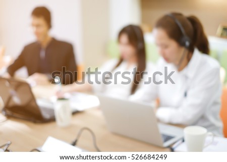 abstract blurred group of asian employee work as call center in office room. Royalty-Free Stock Photo #526684249