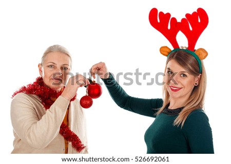 Picture of two happy ladies wearing Christmas costumes on an isolated background