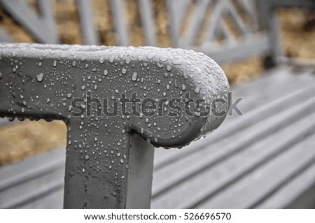 Condensation on a park bench during a cloudy day