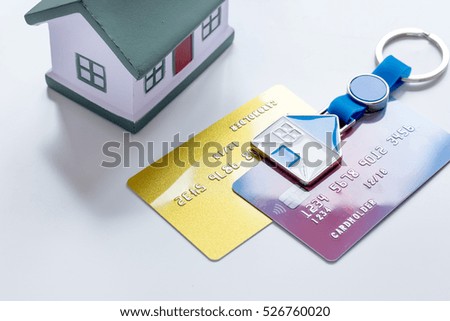 toy house, credit cards - concept mortgage on white background