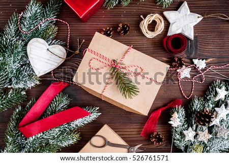 gifts boxes with fir branches on wooden background top view