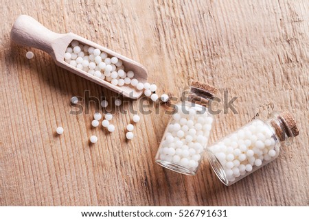 Closeup image of homeopathic medicine consisting of the pills and a bottle containing a liquid homeopathic substance.
 Royalty-Free Stock Photo #526791631