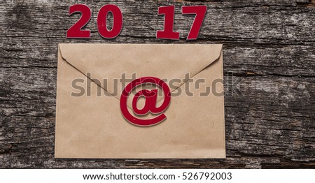 Happy new year 2017 - paper envelope on wooden table 