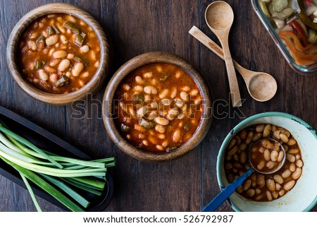 Turkish Kuru Fasulye / Baked Beans in a wooden bowl.
 Royalty-Free Stock Photo #526792987