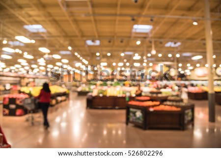 Blur abstract organic fresh produces, fruits and vegetable on shelves in store at Humble, Texas, US. Blurred supermarket, grocery with customers shopping, bokeh light background. Healthy concept. Royalty-Free Stock Photo #526802296