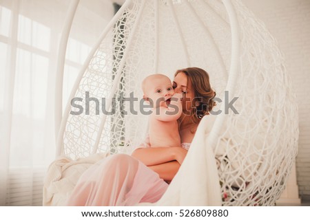 Portrait of a mother with her 4 months old baby indoor