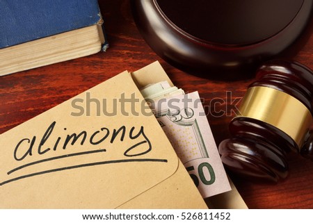 Alimony concept. An envelope with cash on a table. Royalty-Free Stock Photo #526811452