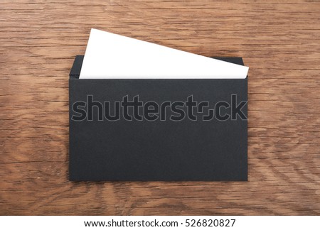 black envelope on  wooden table