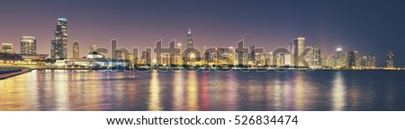 Retro toned panoramic picture of Chicago city skyline at night, USA.