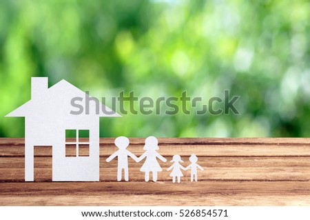 Paper family on wooden table with garden bokeh outdoor theme background.