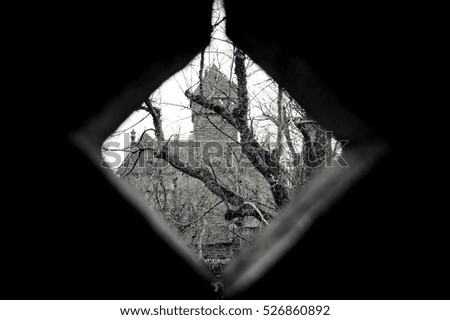Haut-Koenigsbourg castle (Alsace, France) view through window. Black and white.