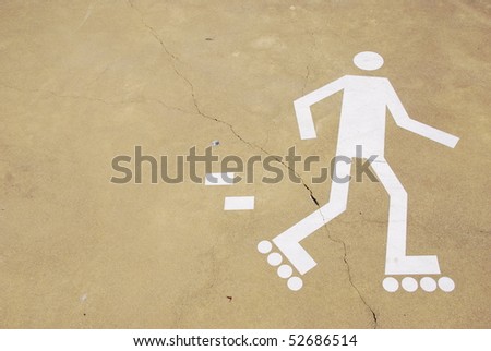 white rollerblading sign on a urban park (yellow cement surface)