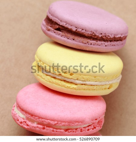 Colorful macaroons over brown background
