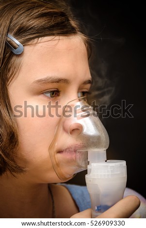 sick girl inhalation therapy by the mask of inhaler
