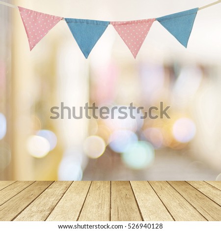 Birthday party flag over blur bokeh background, banner, Pink and blue party flag bunting for happy birthday backdrop, Wood table and blur abstract light background for product display mockup, template