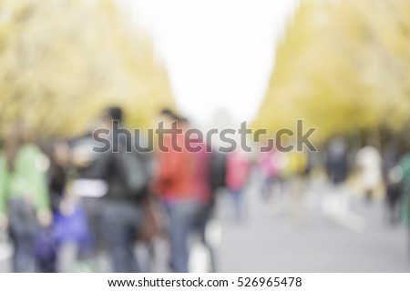 Abstract blur people in autumn park bokeh background  Royalty-Free Stock Photo #526965478