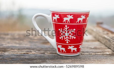 Christmas mug with hot coffee in the winter