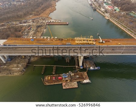 Construction of the bridge across the river. Aerial view.
