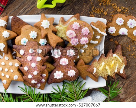 Colorful Christmas gingerbread cookies on wooden background
