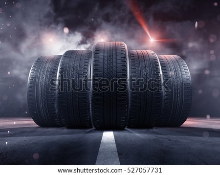 Five tires rolling on a street Royalty-Free Stock Photo #527057731
