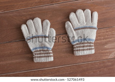 Little gloves  on wooden background