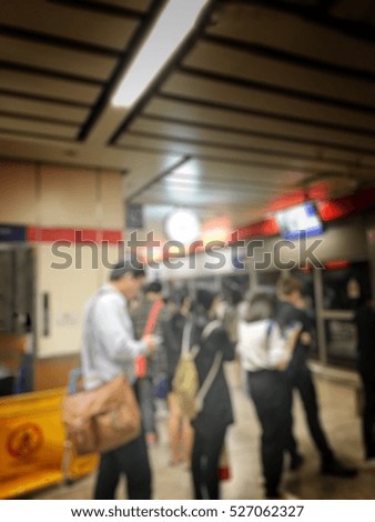 Blurred image of people waiting for subway at station, transportation background with vintage tone.