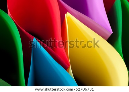 Colorful Paper Elliptical Shapes on a black background.