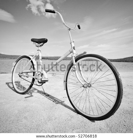 Old old-fashioned bicycle on the beach - a monochrome picture