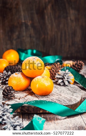 Christmas composition, Tangerines, pine Cones, Snow ,decor,Cinnamon, Walnut. Wooden Background.