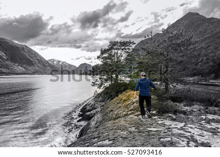 Young man is having fun hiking in Norway