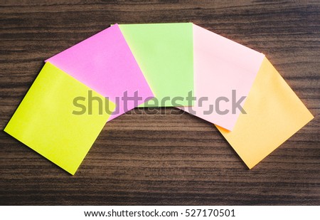 blank sticky note or post it isolated on wood board