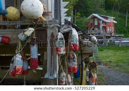 vintage hanging buoys with a red hut in the background, Halibut Cove , Alaska