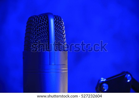 Condenser microphone on a rack. blue lighting