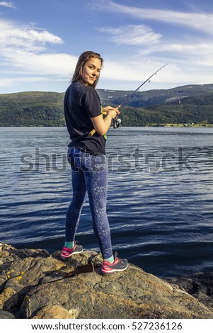 Young woman is fishing in Norway