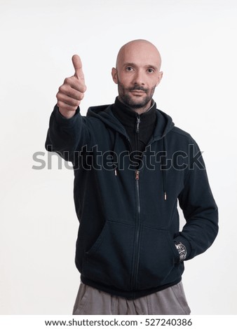 Caucasian man on white background making OK signal with hand