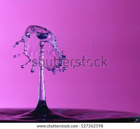 This is a high speed photograph of 2 water drops colliding.